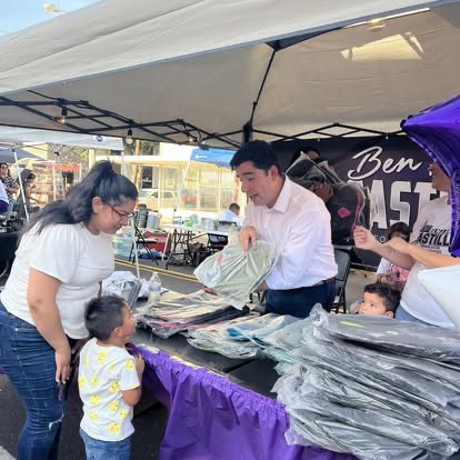 Ben Castillo handing out shirts to families